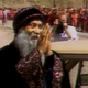Bhagwan Shree Rajneesh greets his followers.